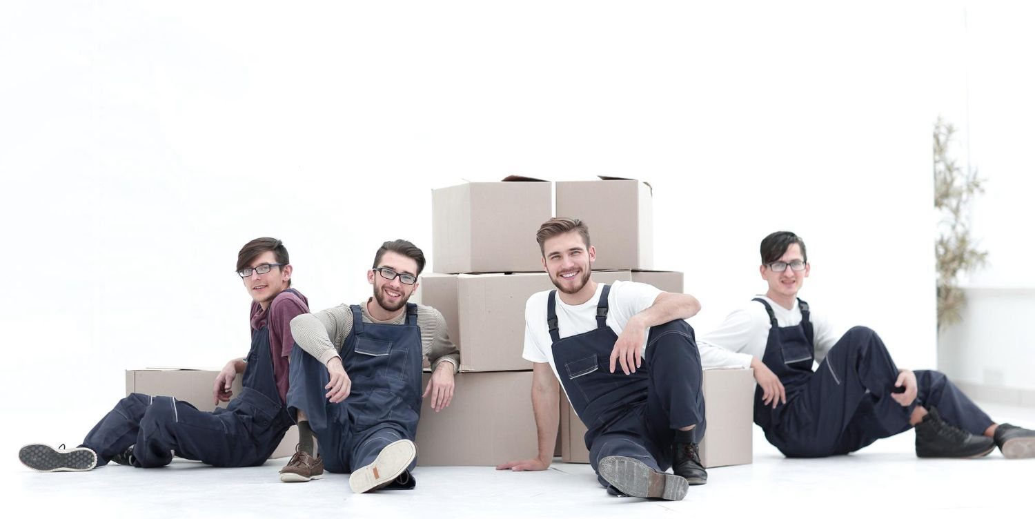 A clearance team carrying boxes out of a home